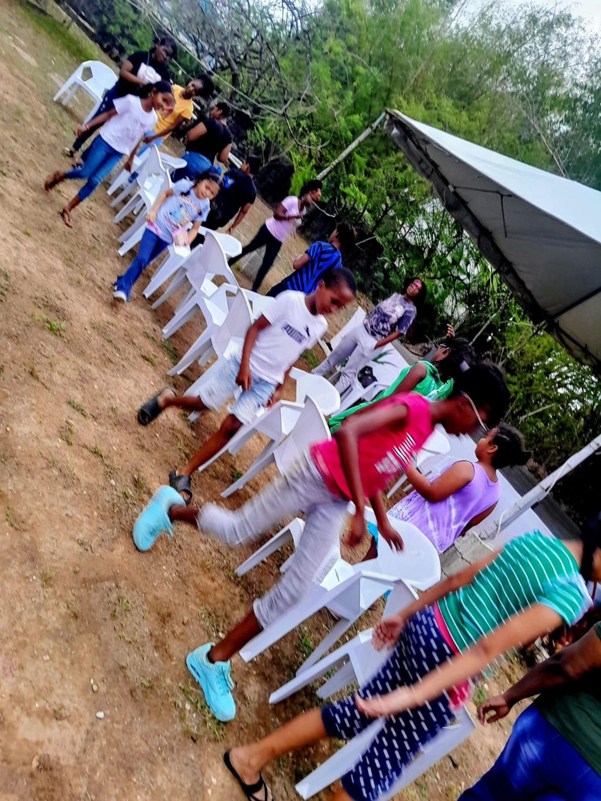 Children playing musical chairs at a youth activity hosted by Arouca Soul Kitchen in Arouca, Trinidad